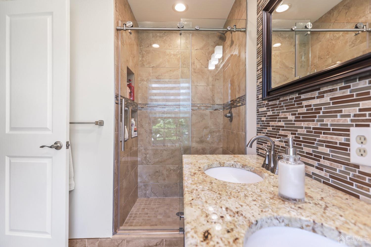 7 Mountbatten Drive Old Bridge, NJ 08857 - Photo 29 of 42 a bathroom with a granite countertop shower sink and mirror