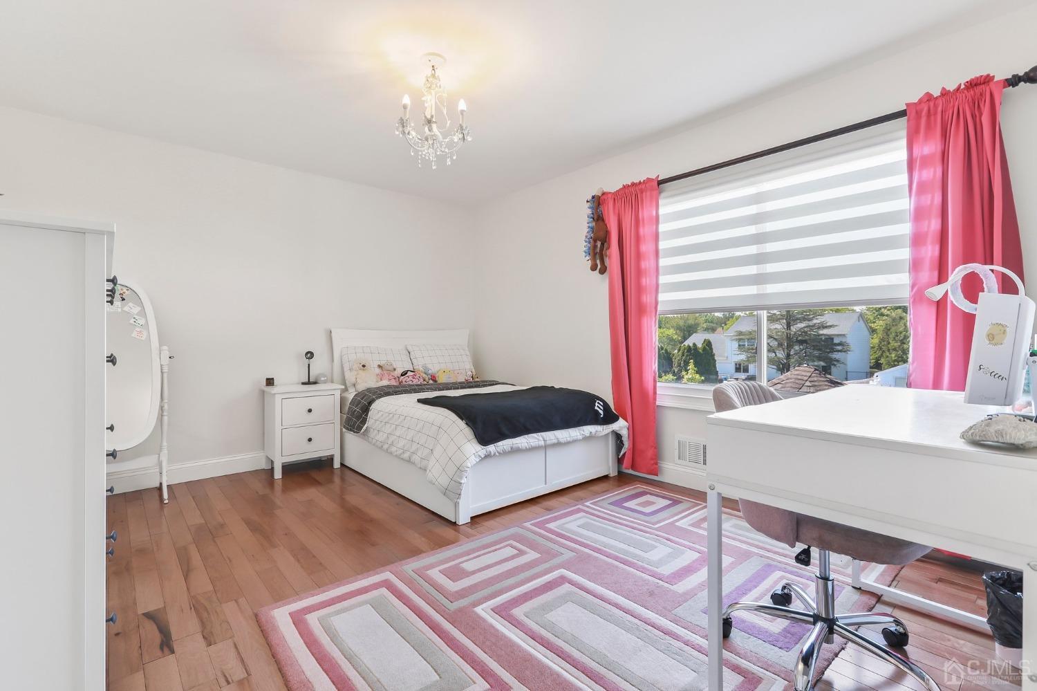 7 Mountbatten Drive Old Bridge, NJ 08857 - Photo 32 of 42 a spacious bedroom with a bed a table with wooden floor