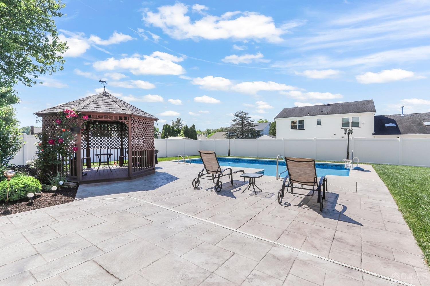 7 Mountbatten Drive Old Bridge, NJ 08857 - Photo 35 of 42 a view of a patio with a table and chairs under an umbrella