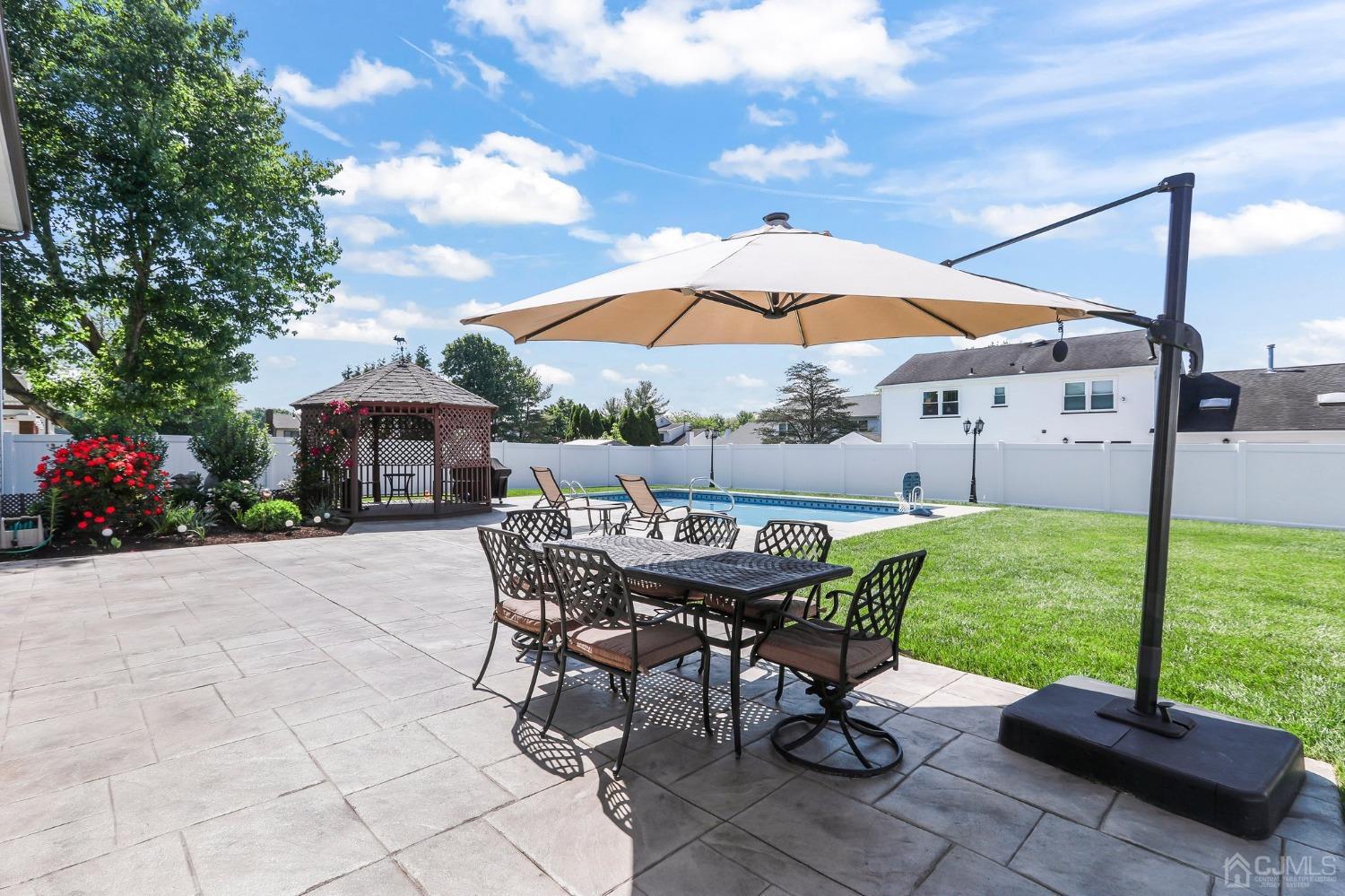 7 Mountbatten Drive Old Bridge, NJ 08857 - Photo 39 of 42 a view of a patio with a table and chairs under an umbrella