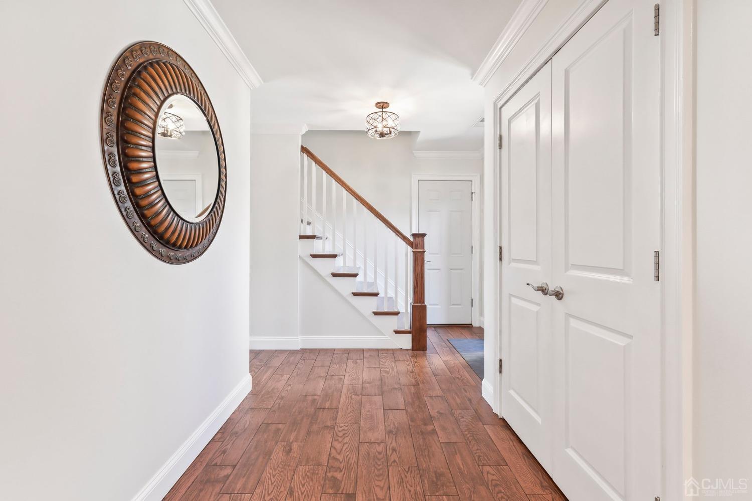 7 Mountbatten Drive Old Bridge, NJ 08857 - Photo 9 of 42 a view of a hallway with wooden floor and staircase