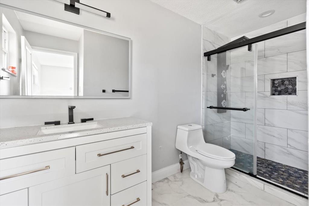 1436 Mardrake Road Daytona Beach, FL 32114 - Photo 11 of 37 a bathroom with a sink toilet and shower