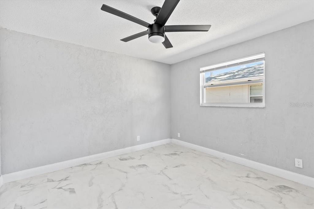 1436 Mardrake Road Daytona Beach, FL 32114 - Photo 12 of 37 an empty room with a window and a fan