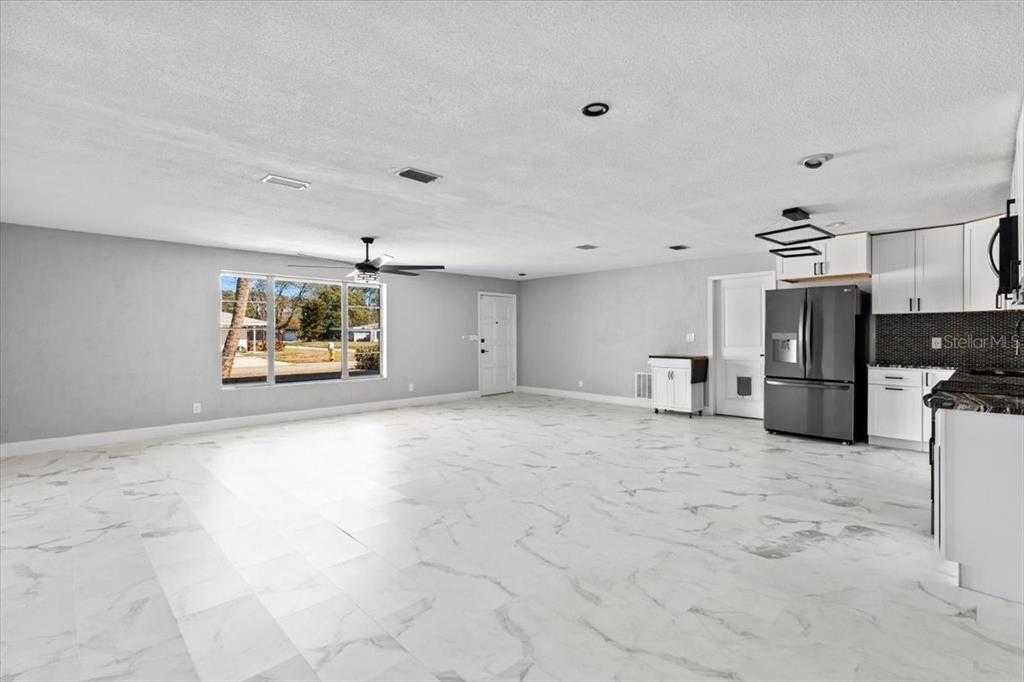 1436 Mardrake Road Daytona Beach, FL 32114 - Photo 4 of 37 a view of a kitchen with a sink and a refrigerator