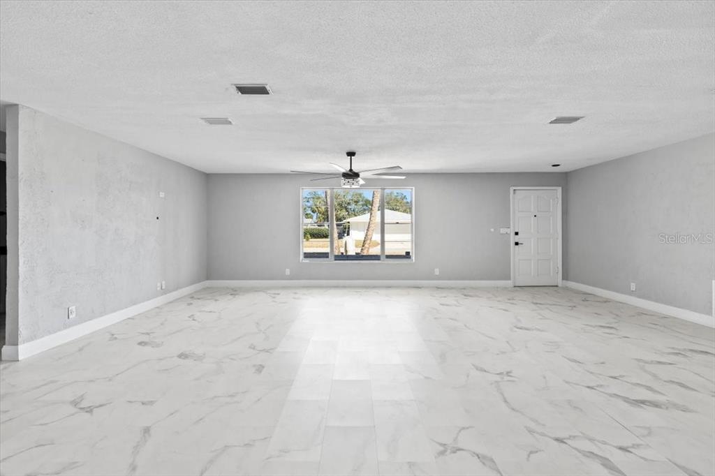 1436 Mardrake Road Daytona Beach, FL 32114 - Photo 7 of 37 an empty room with windows and mountain view