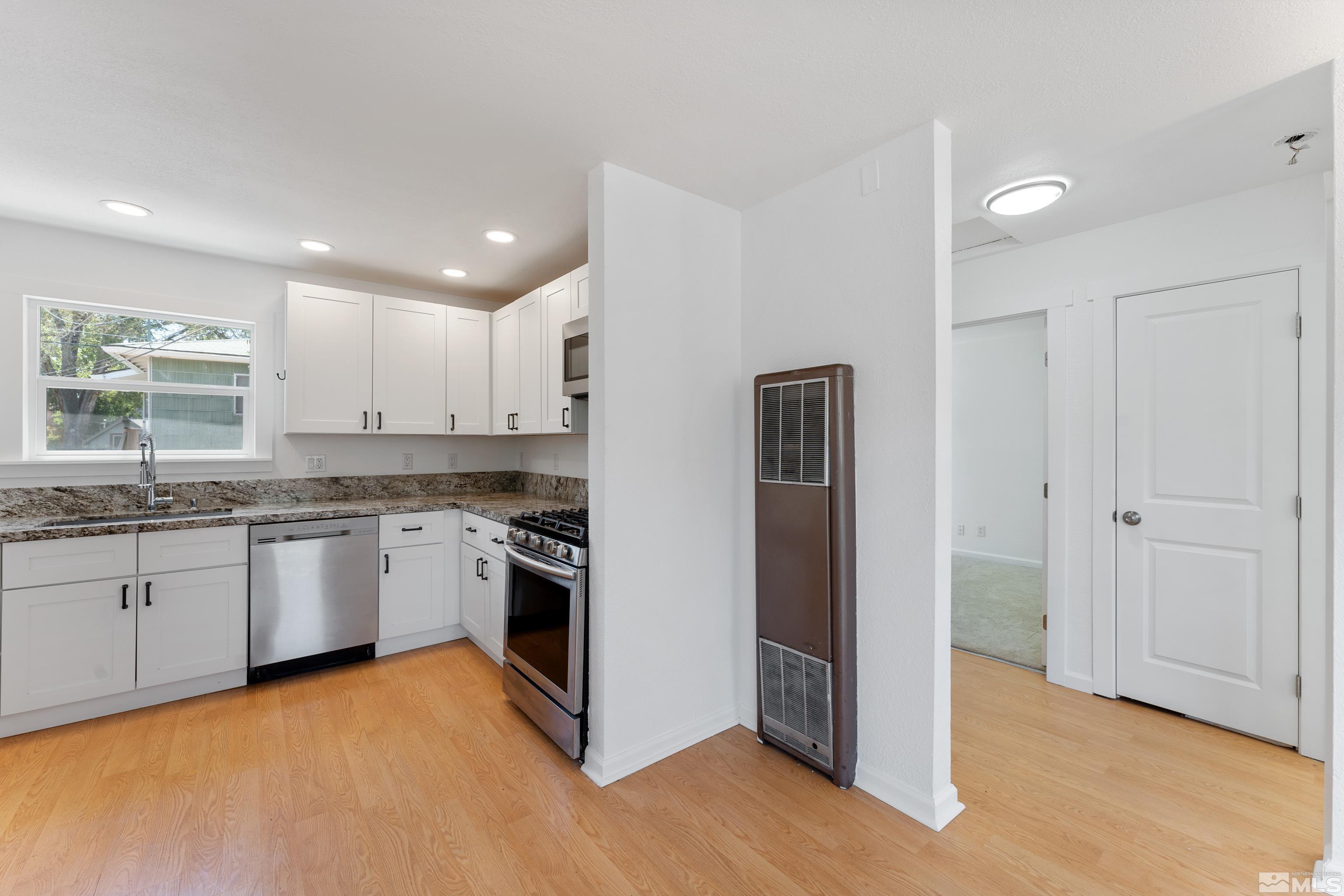 780 Moran Street Reno, NV 89502 - Photo 8 of 40 a kitchen with stainless steel appliances granite countertop a refrigerator and a sink
