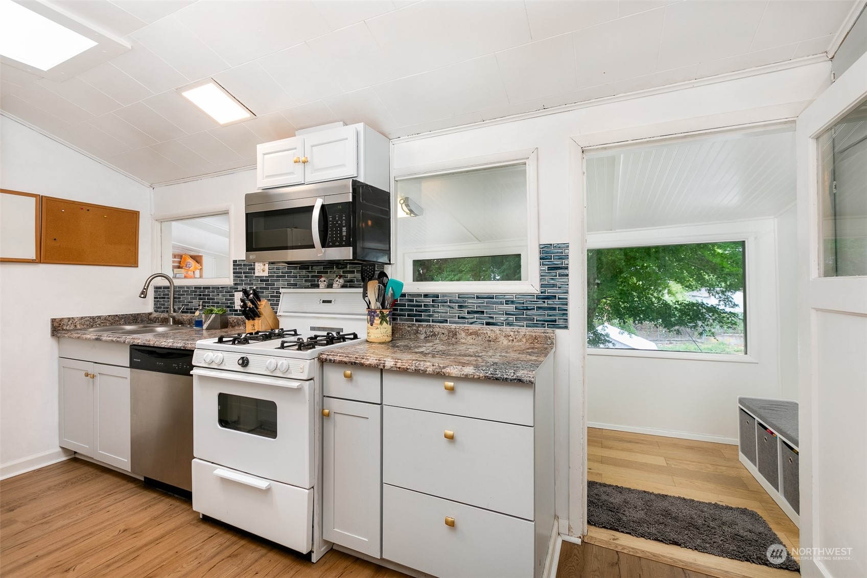 3408 Rockefeller Avenue Everett, WA 98201 - Photo 14 of 36 a kitchen with a stove a sink and a microwave