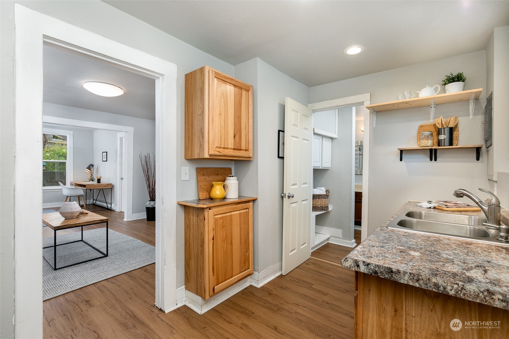 3408 Rockefeller Avenue Everett, WA 98201 - Photo 25 of 36 a kitchen with granite countertop wooden floors and view of living room