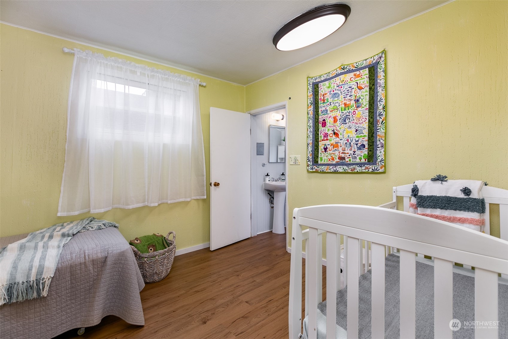 3408 Rockefeller Avenue Everett, WA 98201 - Photo 8 of 36 a bedroom with a bed and wooden floor