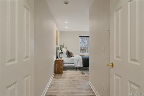a view of a bedroom with furniture and wooden floor