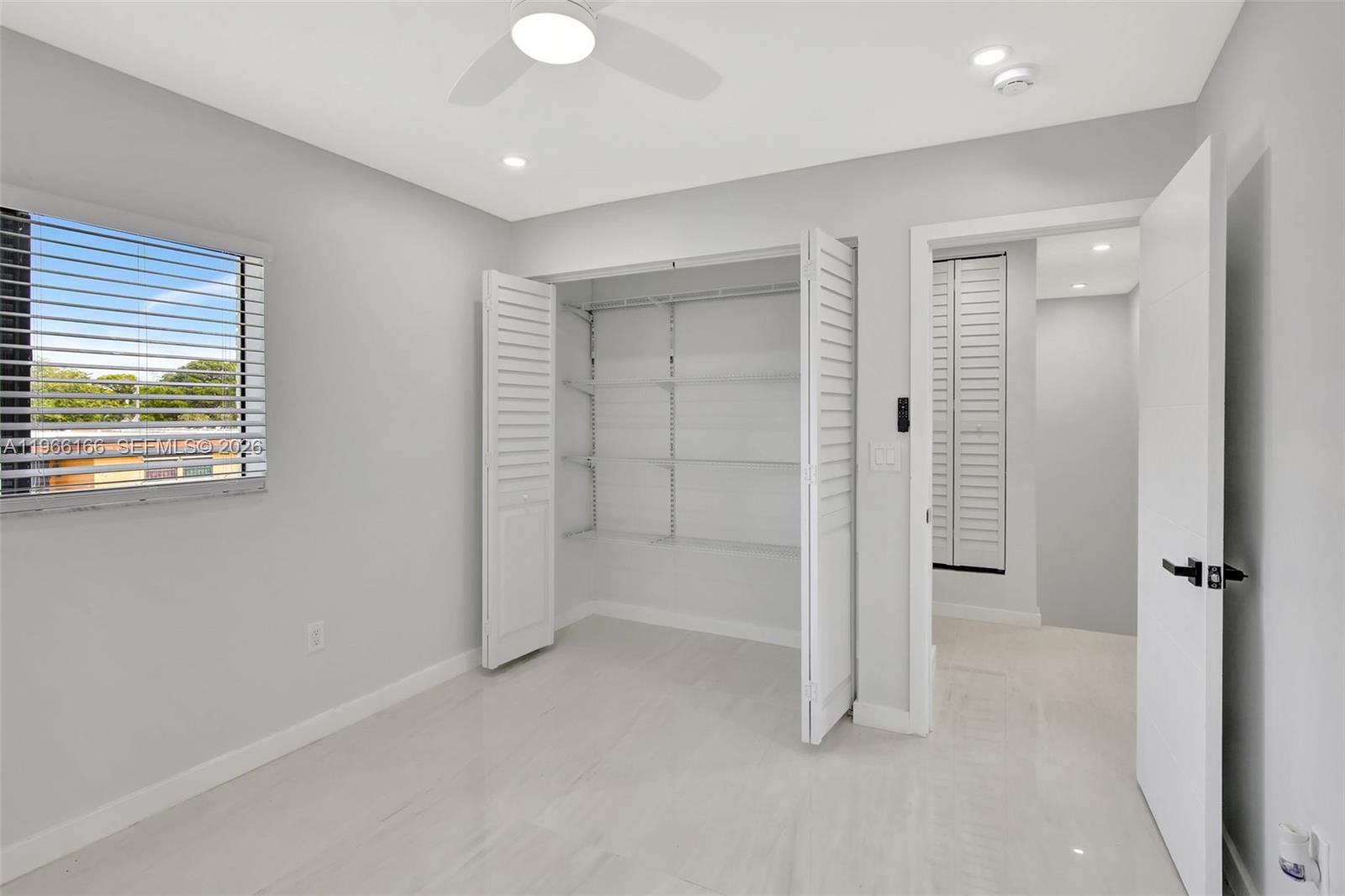 3916 Northwest 207 St Road Miami Gardens, FL 33055 - Photo 34 of 38 wooden floor and windows in an empty room