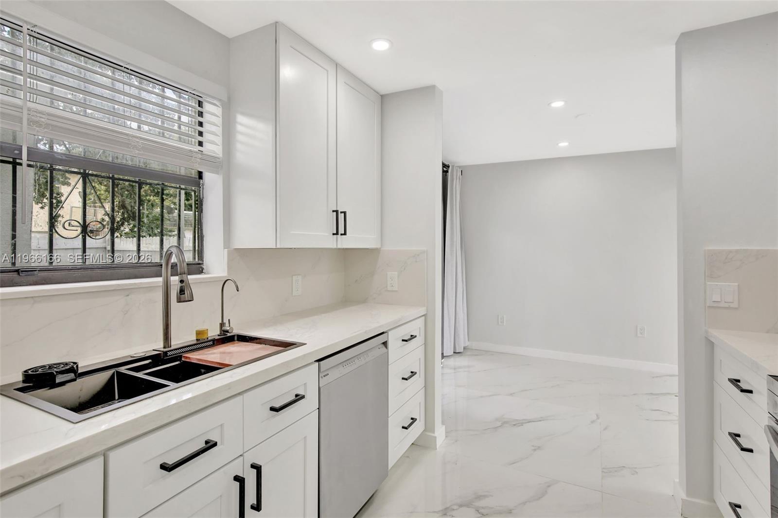 3916 Northwest 207 St Road Miami Gardens, FL 33055 - Photo 5 of 38 a kitchen with granite countertop a sink and cabinets