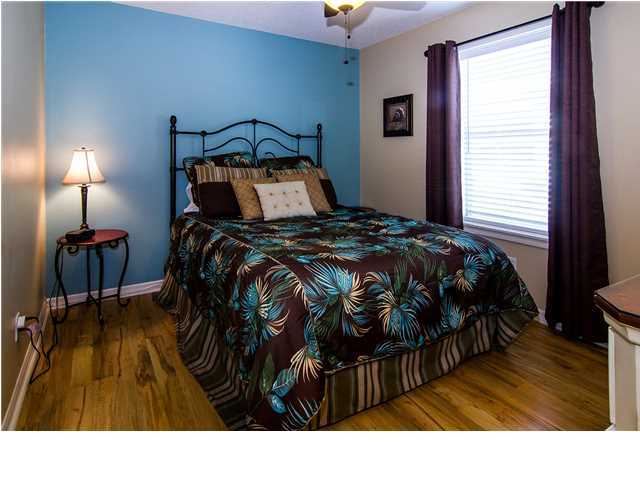11 Beachside Drive, Unit 1023 Santa Rosa Beach, FL 32459 - Photo 11 of 24 a bedroom with a bed and wooden floor