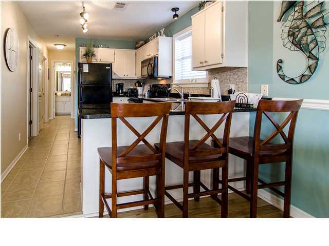 11 Beachside Drive, Unit 1023 Santa Rosa Beach, FL 32459 - Photo 5 of 24 a kitchen view of a dining table chairs and window
