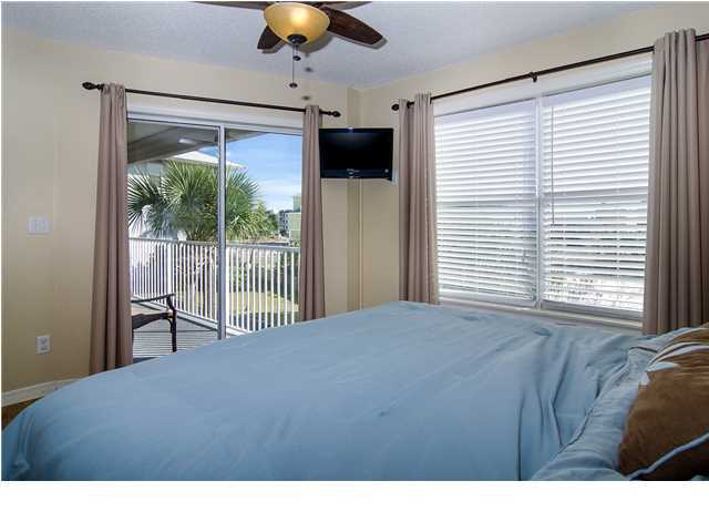 11 Beachside Drive, Unit 1023 Santa Rosa Beach, FL 32459 - Photo 9 of 24 a bedroom with a bed window and a chandelier