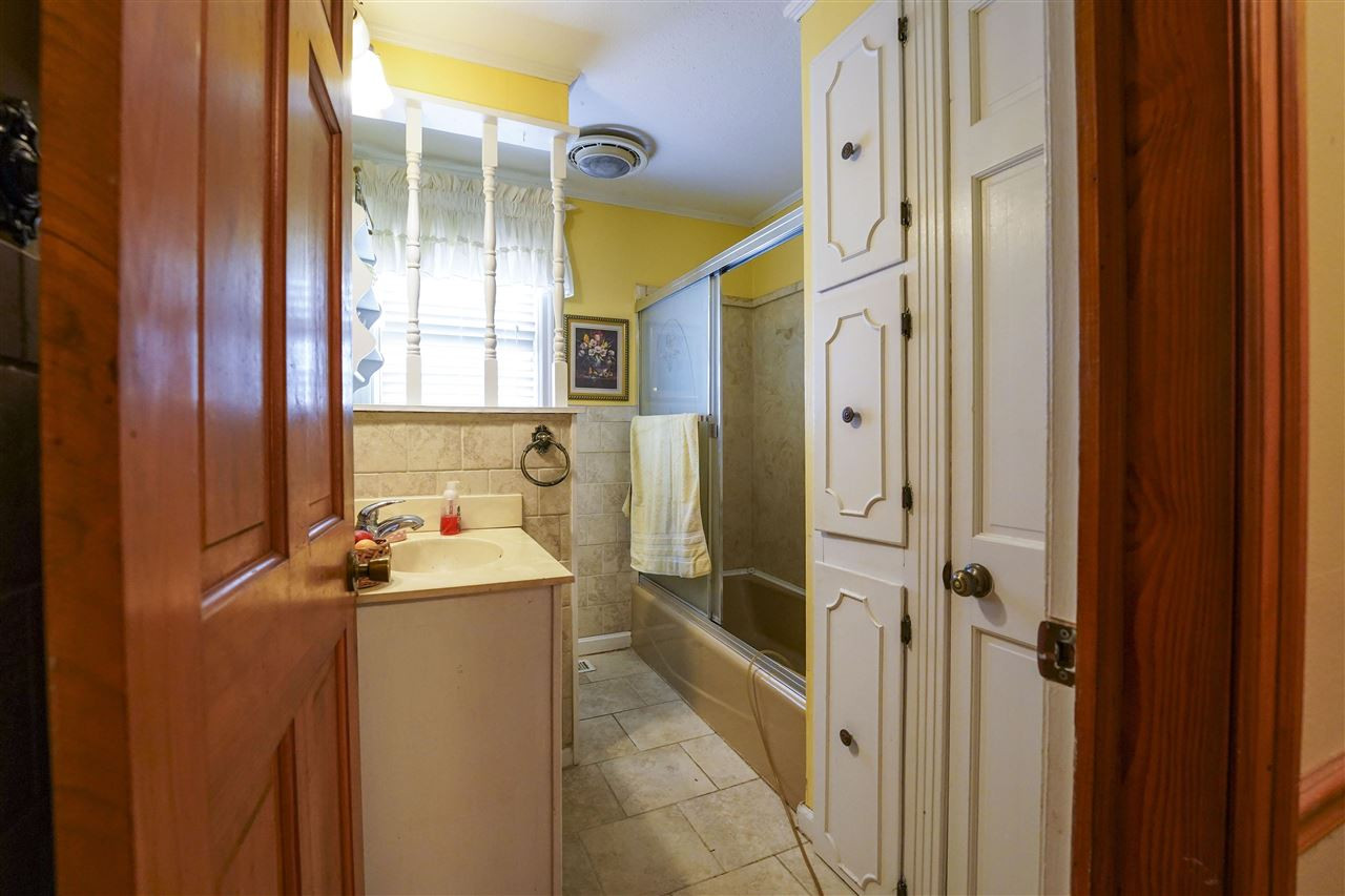 309 Hopper Street Rutherford, TN 38369 - Photo 11 of 14 a bathroom with a sink a mirror and a shower