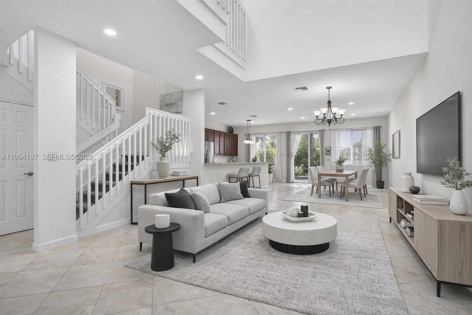 a living room with furniture and a chandelier