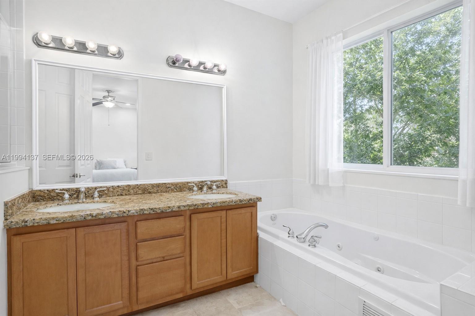 728 Southeast 2nd Street Pompano Beach, FL 33060 - Photo 11 of 27 a bathroom with a granite countertop sink and a bathtub