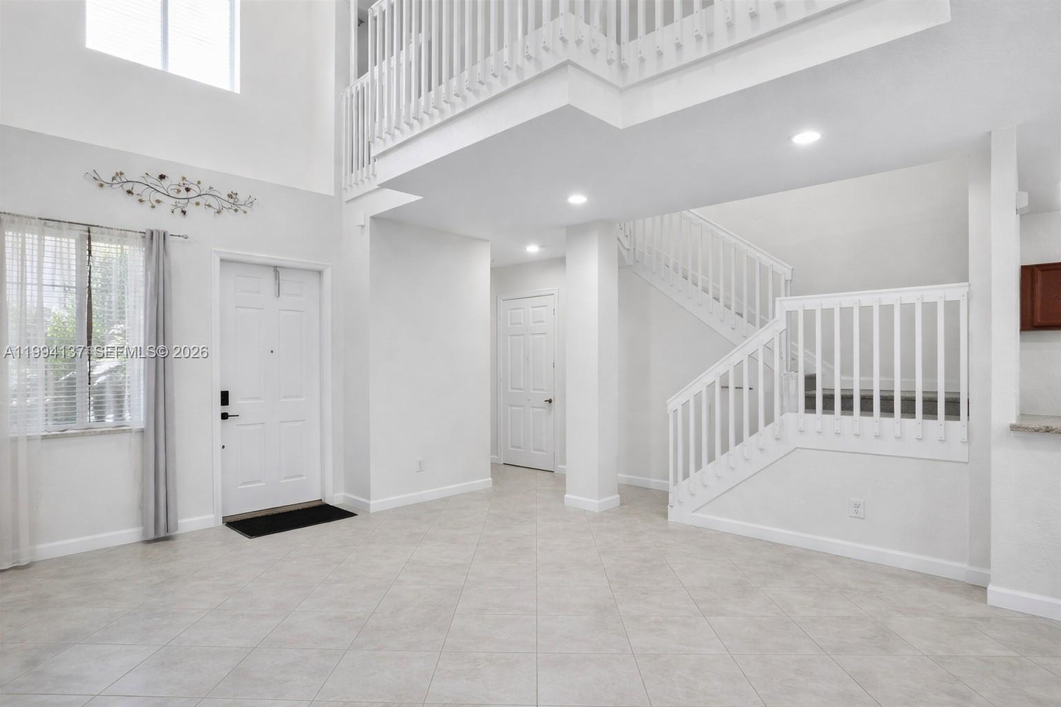 728 Southeast 2nd Street Pompano Beach, FL 33060 - Photo 2 of 27 wooden floor in an empty room with a window