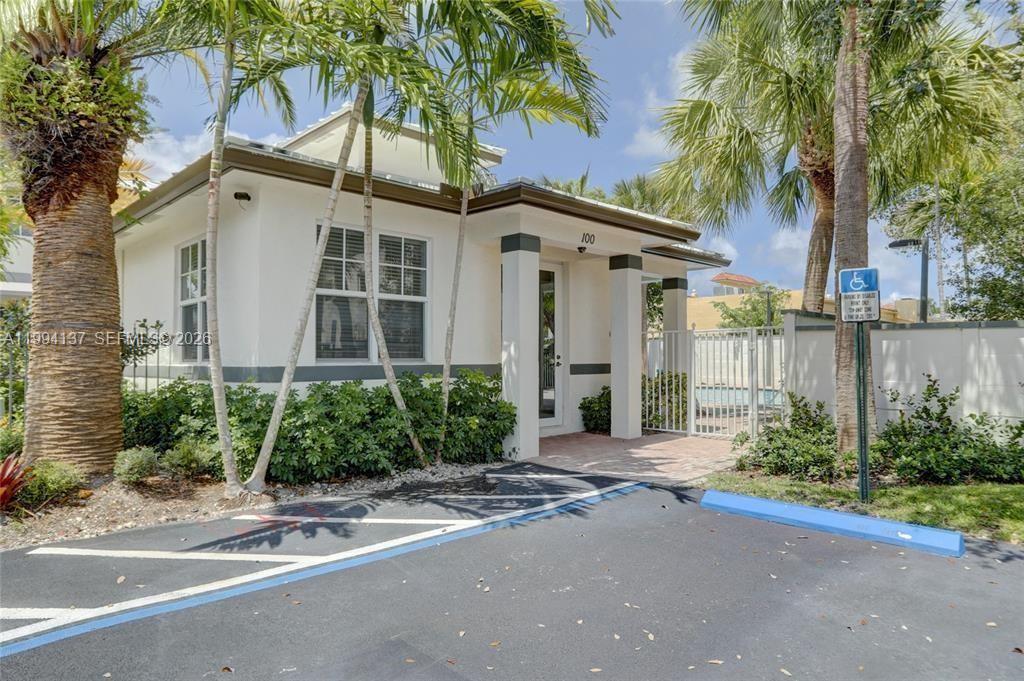 728 Southeast 2nd Street Pompano Beach, FL 33060 - Photo 23 of 27 a front view of a house with a yard and a garage