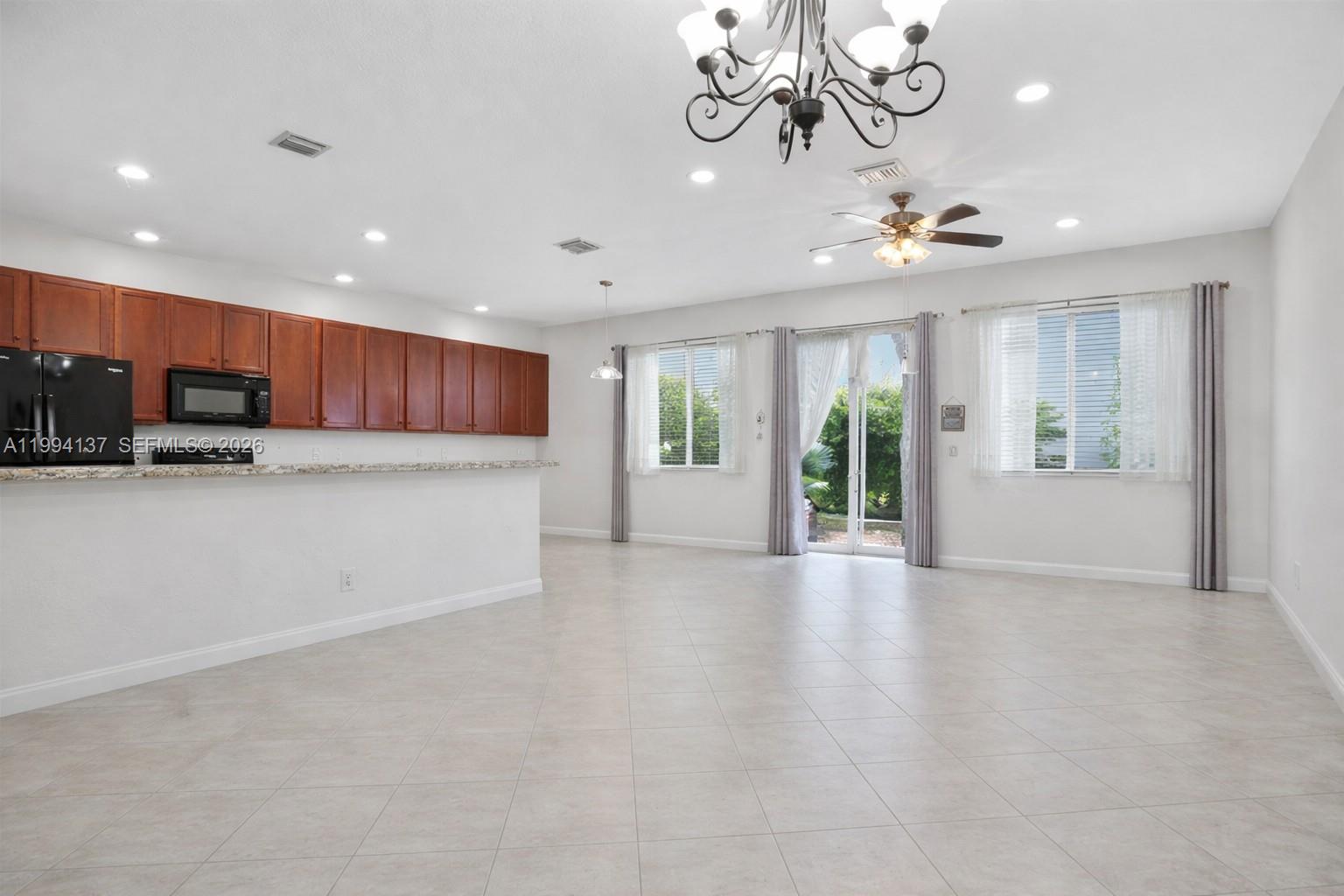 728 Southeast 2nd Street Pompano Beach, FL 33060 - Photo 5 of 27 a view of an empty room with kitchen and a window