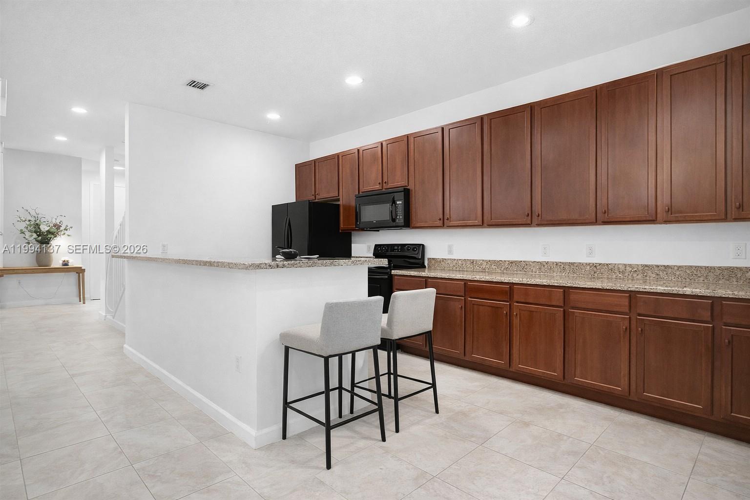 728 Southeast 2nd Street Pompano Beach, FL 33060 - Photo 7 of 27 a kitchen with a sink cabinets and wooden floor