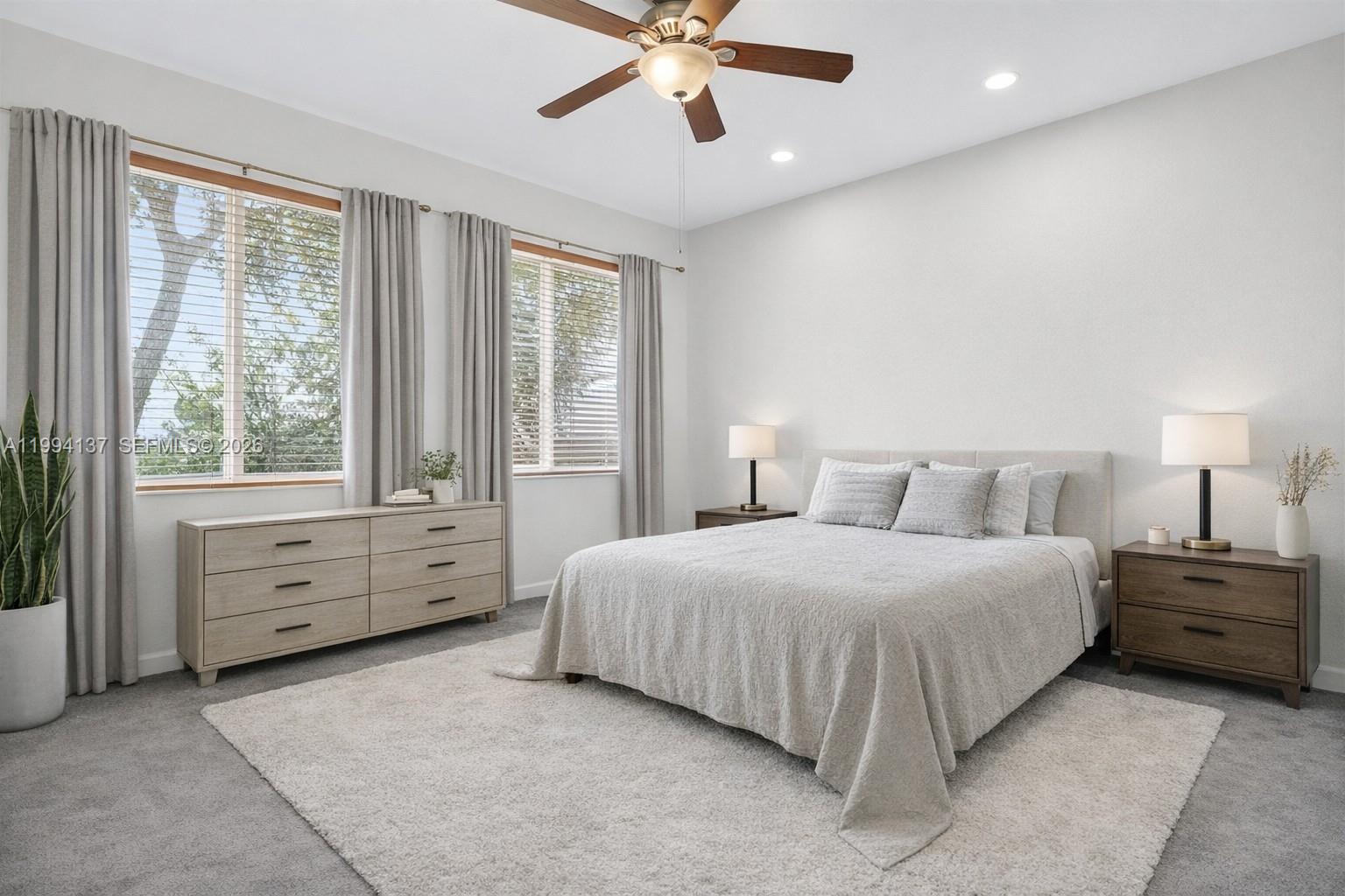 728 Southeast 2nd Street Pompano Beach, FL 33060 - Photo 9 of 27 a bedroom with a bed and a chandelier