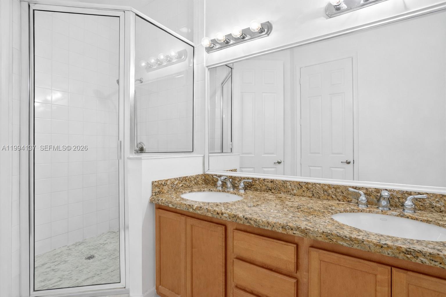 728 Southeast 2nd Street Pompano Beach, FL 33060 - Photo 10 of 27 a bathroom with a granite countertop sink and a mirror
