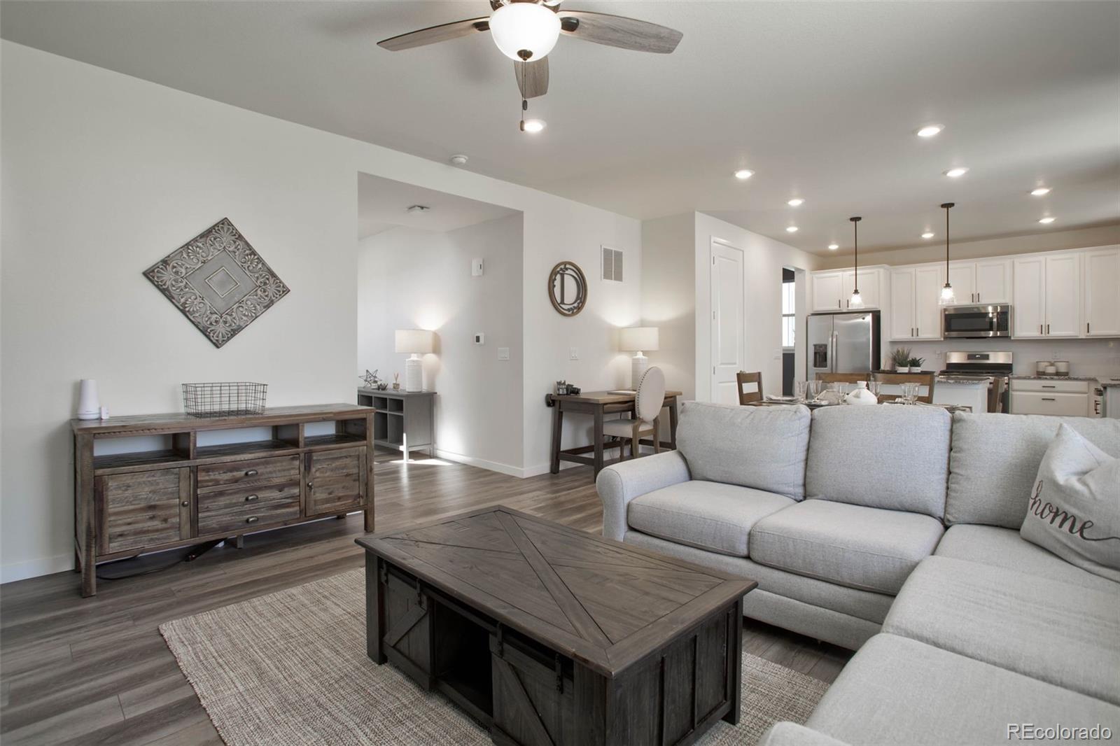 1131 Williams Loop Elizabeth, CO 80107 - Photo 11 of 40 a living room with furniture kitchen view and a wooden floor