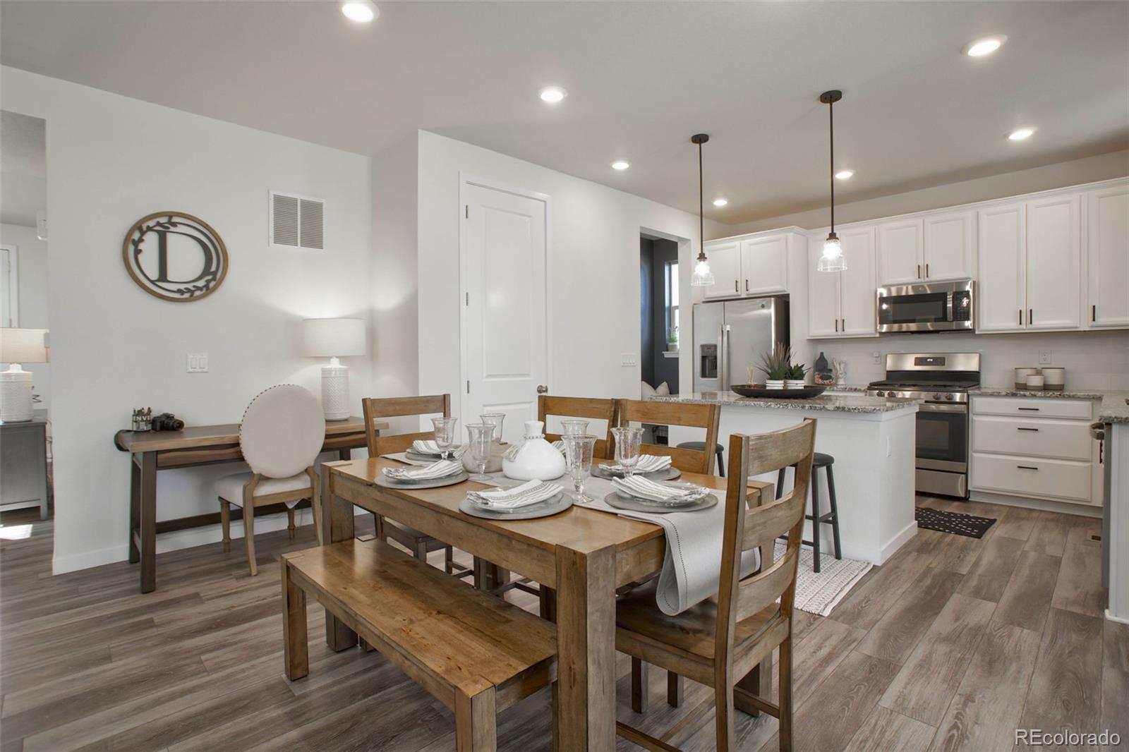 1131 Williams Loop Elizabeth, CO 80107 - Photo 12 of 40 a large kitchen with a table and chairs