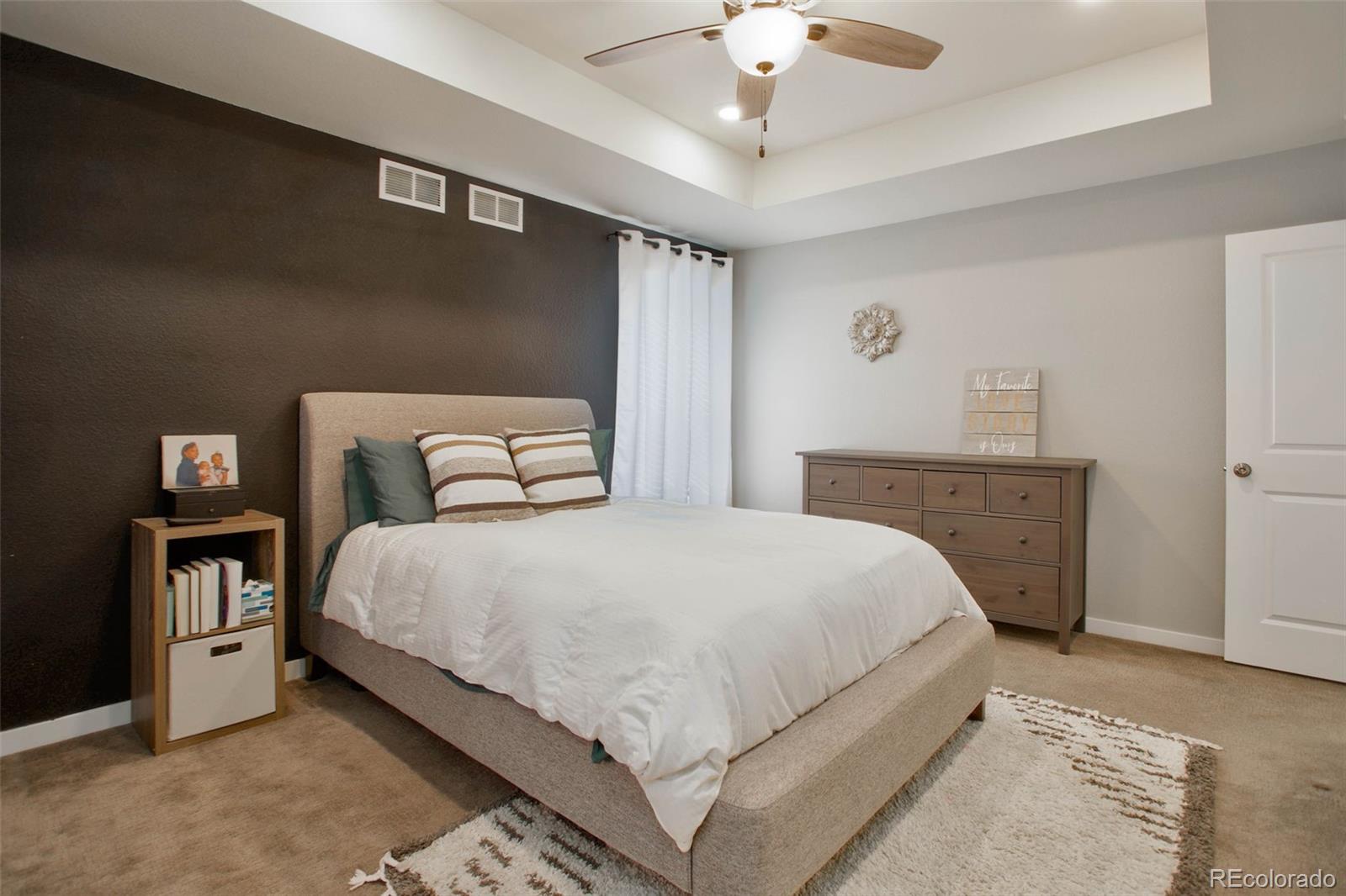 1131 Williams Loop Elizabeth, CO 80107 - Photo 23 of 40 a bedroom with a bed and a chandelier