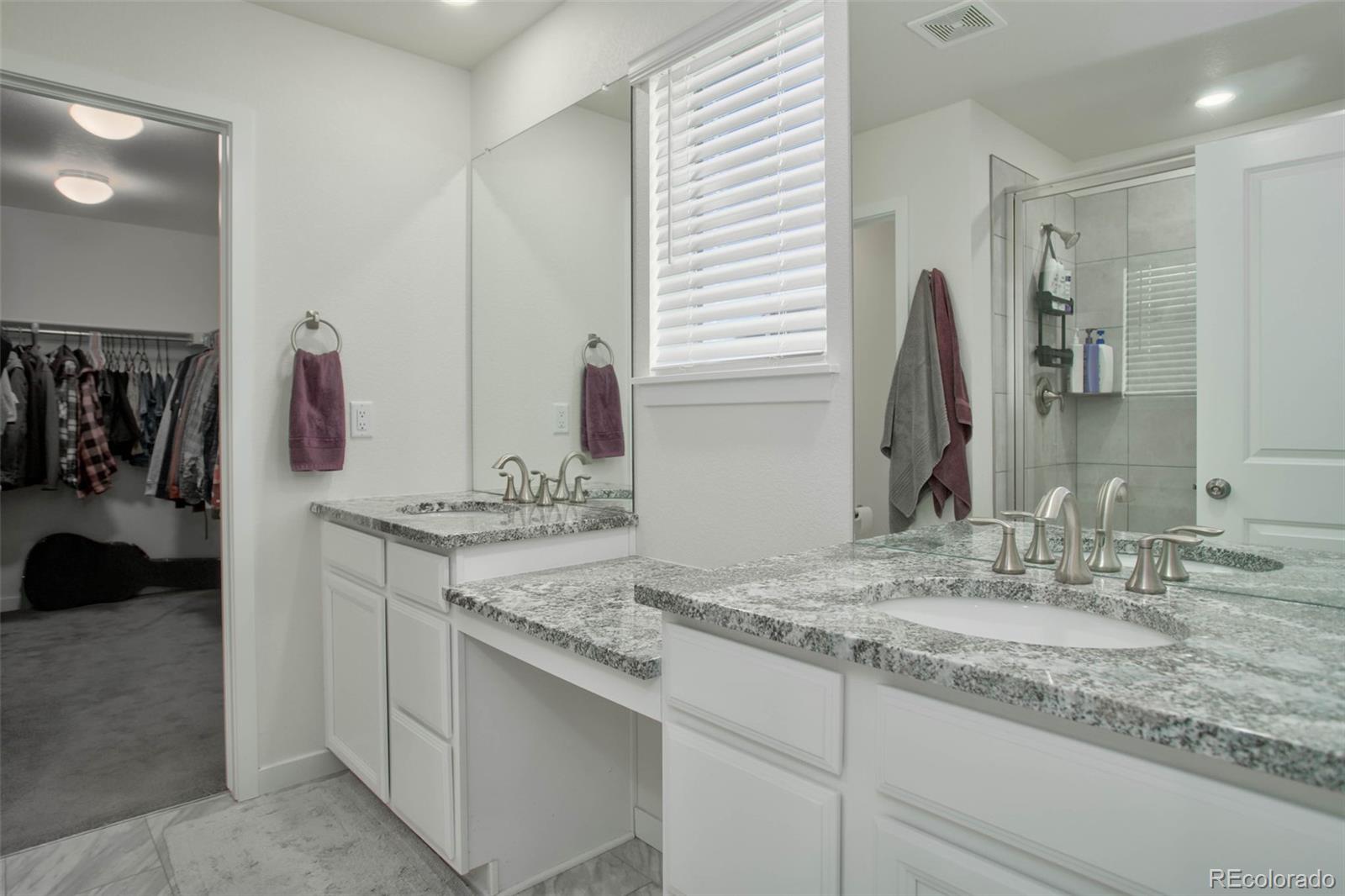 1131 Williams Loop Elizabeth, CO 80107 - Photo 25 of 40 a bathroom with a sink vanity and a mirror