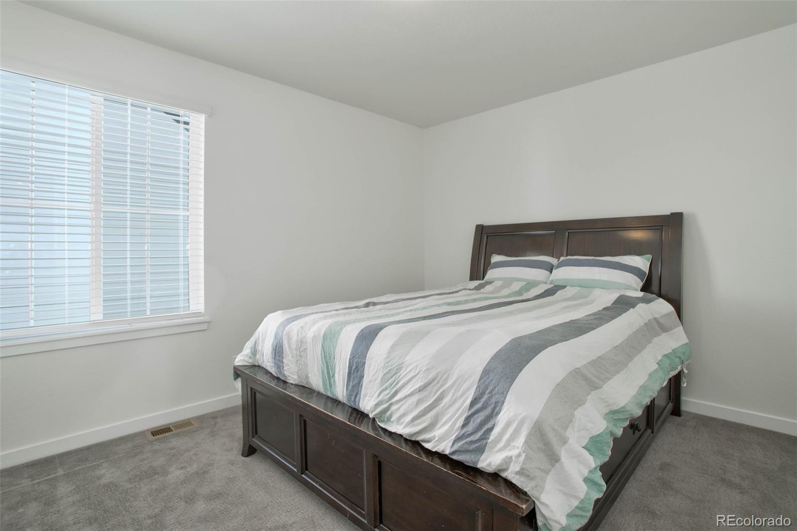 1131 Williams Loop Elizabeth, CO 80107 - Photo 31 of 40 a bedroom with a bed and window