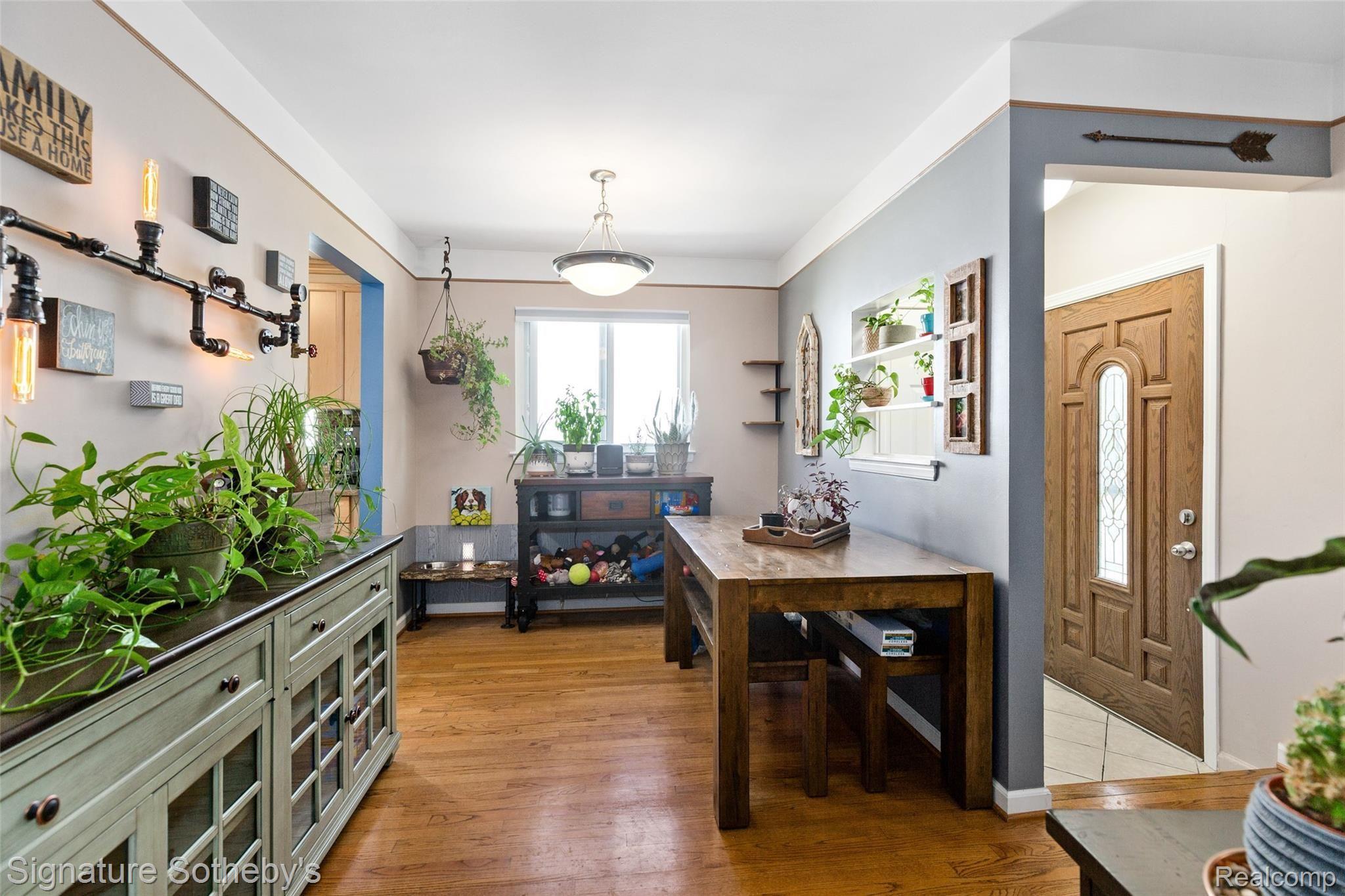 Foyer with ceramic tile floor and newer exterior door, dining area