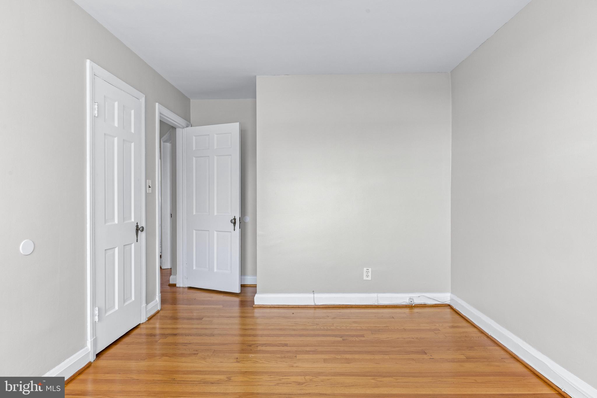 313 Greenlow Road Baltimore, MD 21228 - Photo 28 of 38 a view of an empty room with wooden floor