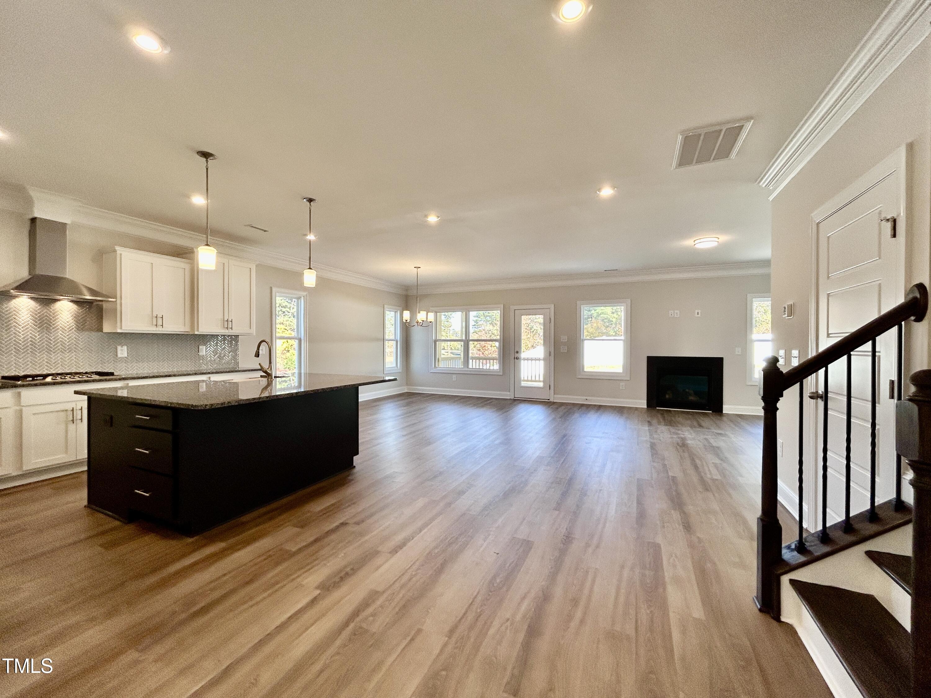 1220 Marsh Hawk Way Wake Forest, NC 27587 - Photo 11 of 23 a room with wooden floors and black cabinets