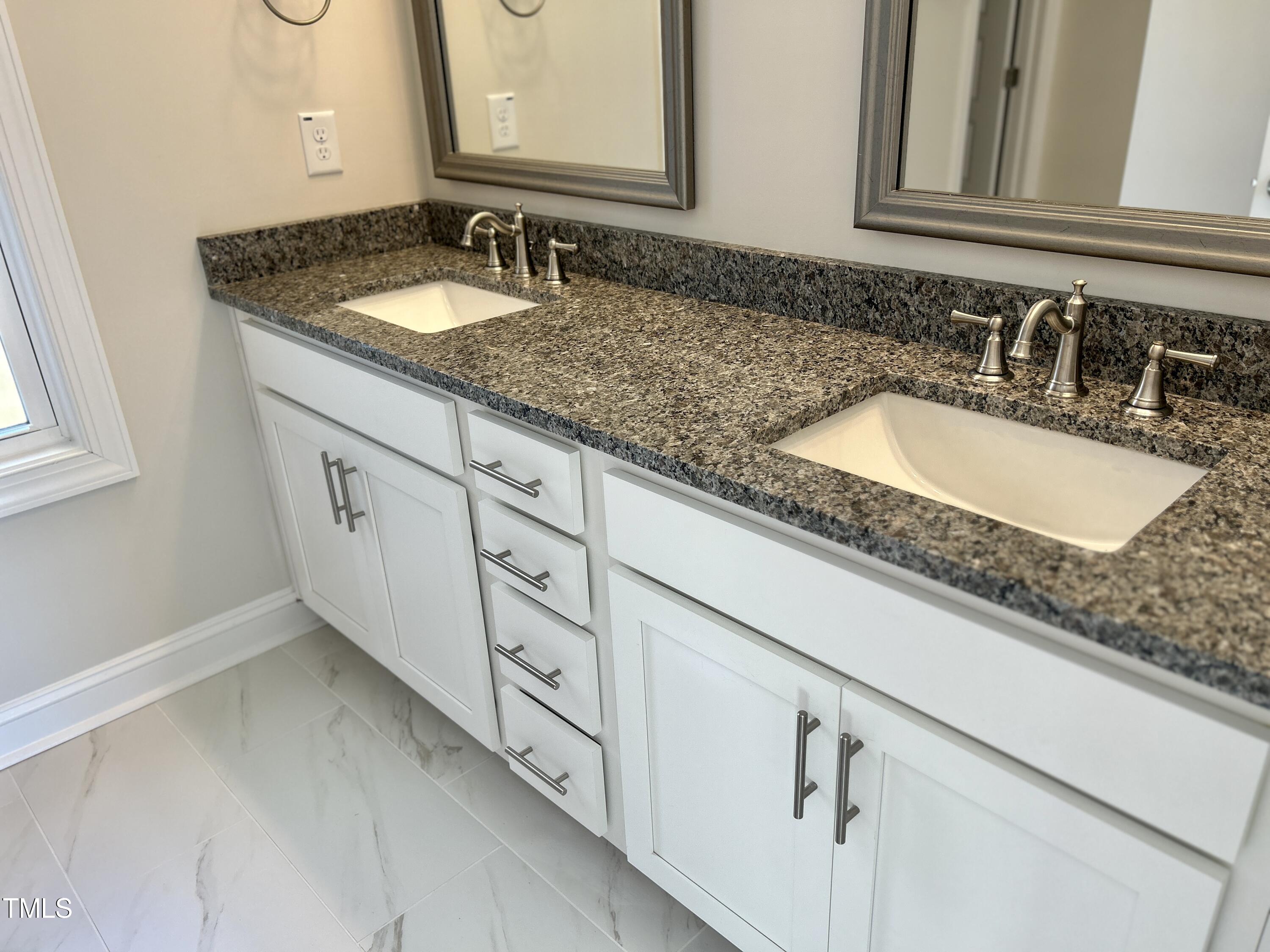1220 Marsh Hawk Way Wake Forest, NC 27587 - Photo 16 of 23 a bathroom with sink and mirror