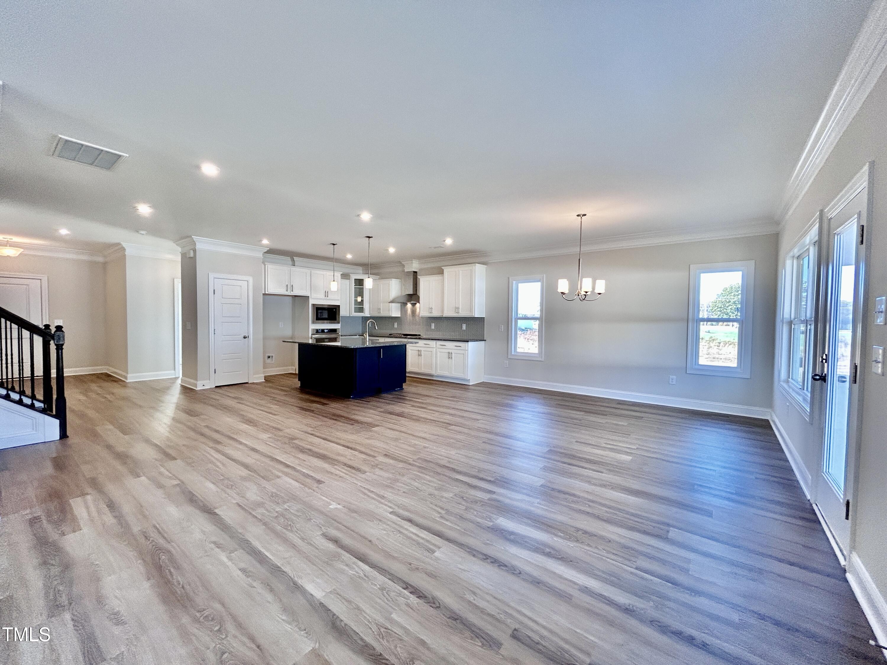 1220 Marsh Hawk Way Wake Forest, NC 27587 - Photo 4 of 23 a view of a big room with wooden floor and windows