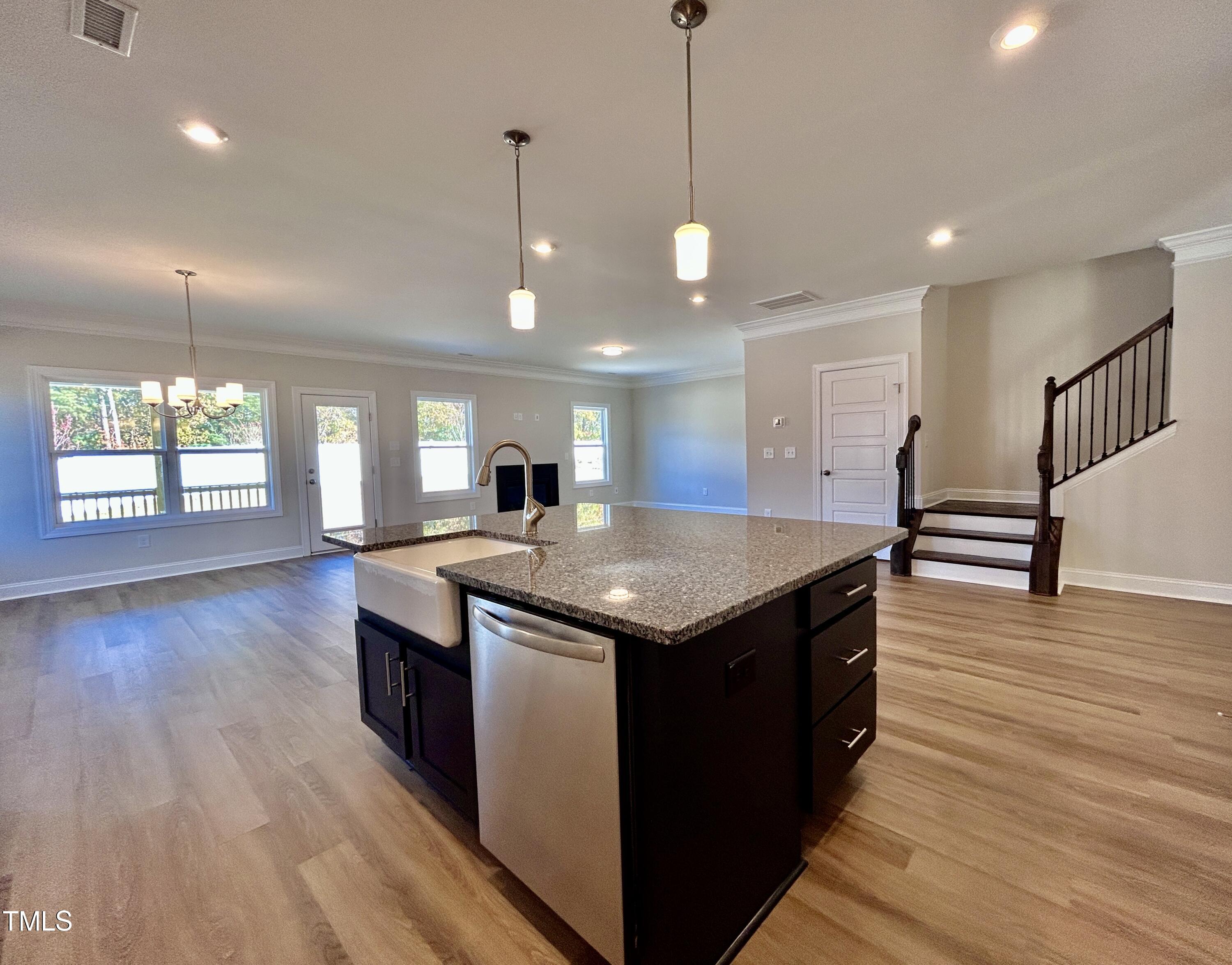 1220 Marsh Hawk Way Wake Forest, NC 27587 - Photo 8 of 23 a kitchen with stainless steel appliances granite countertop wooden floors and a sink