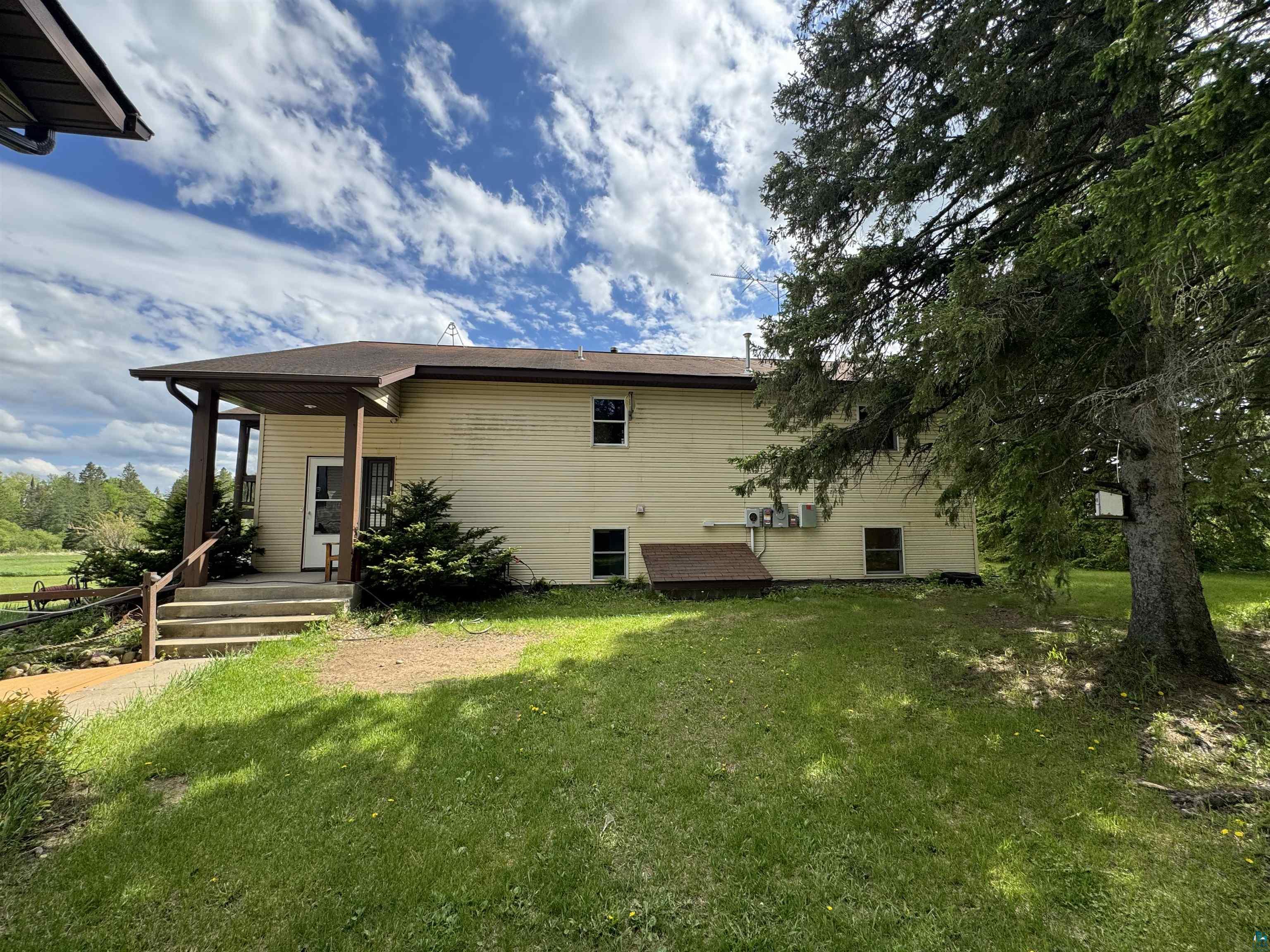 7264 NE Road Wright, MN 55798 - Photo 2 of 17 Back of house featuring a yard