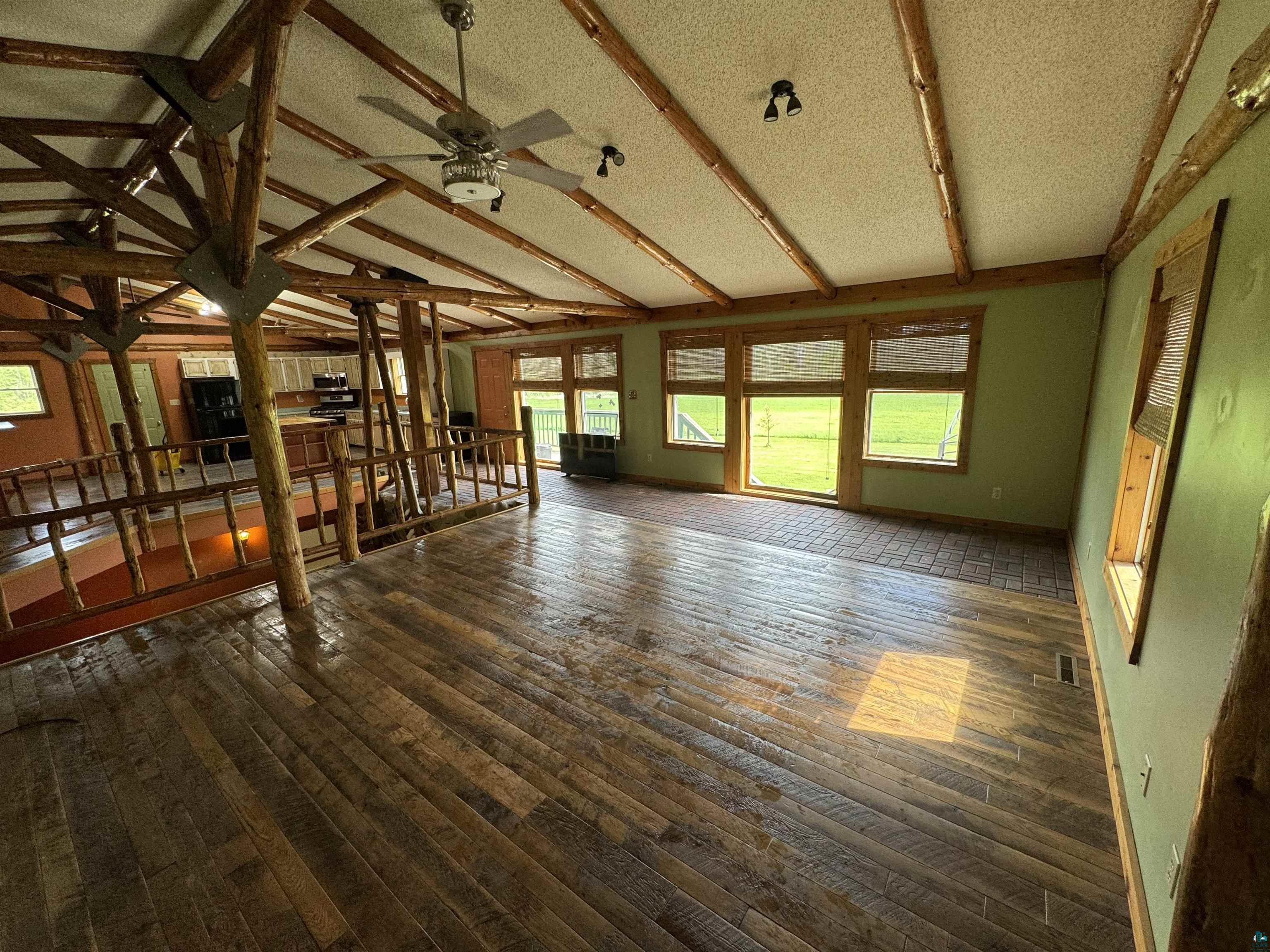 7264 NE Road Wright, MN 55798 - Photo 6 of 17 Interior space featuring hardwood / wood-style floors, ceiling fan, a textured ceiling, and lofted ceiling