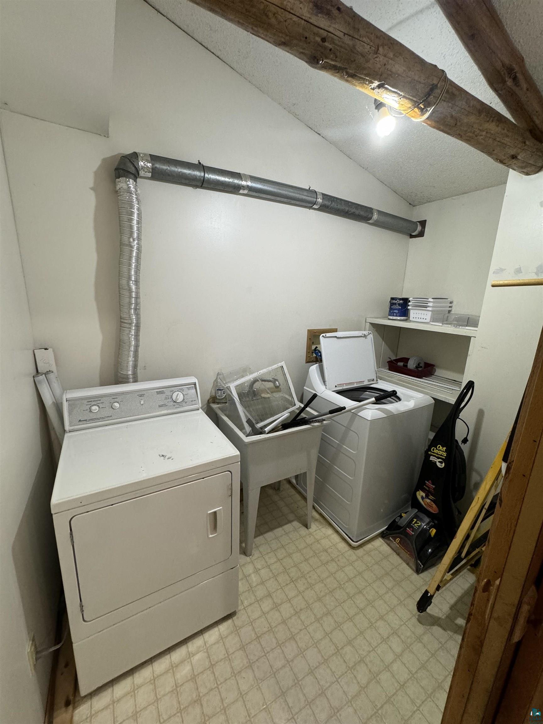 7264 NE Road Wright, MN 55798 - Photo 8 of 17 Clothes washing area with light tile flooring and washing machine and clothes dryer