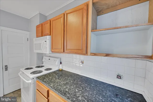 a kitchen that has a sink and a stove
