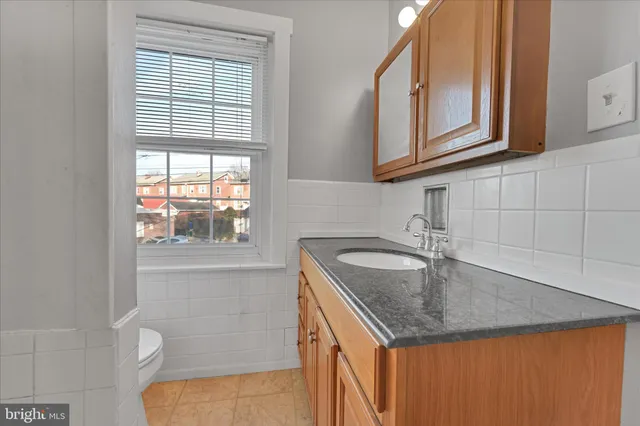 a kitchen with stainless steel appliances granite countertop a sink and a window