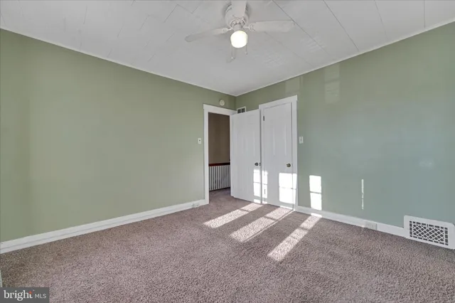 a view of a livingroom with a ceiling fan and window
