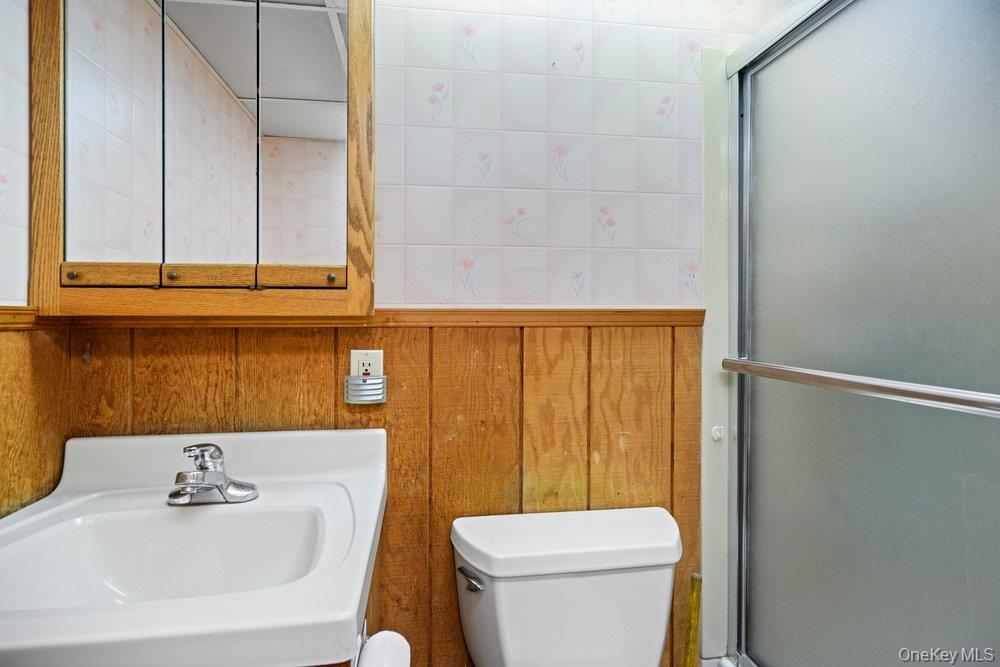 101 Sexton Road West Babylon, NY 11704 - Photo 25 of 33 a bathroom with a sink a toilet and shower curtain