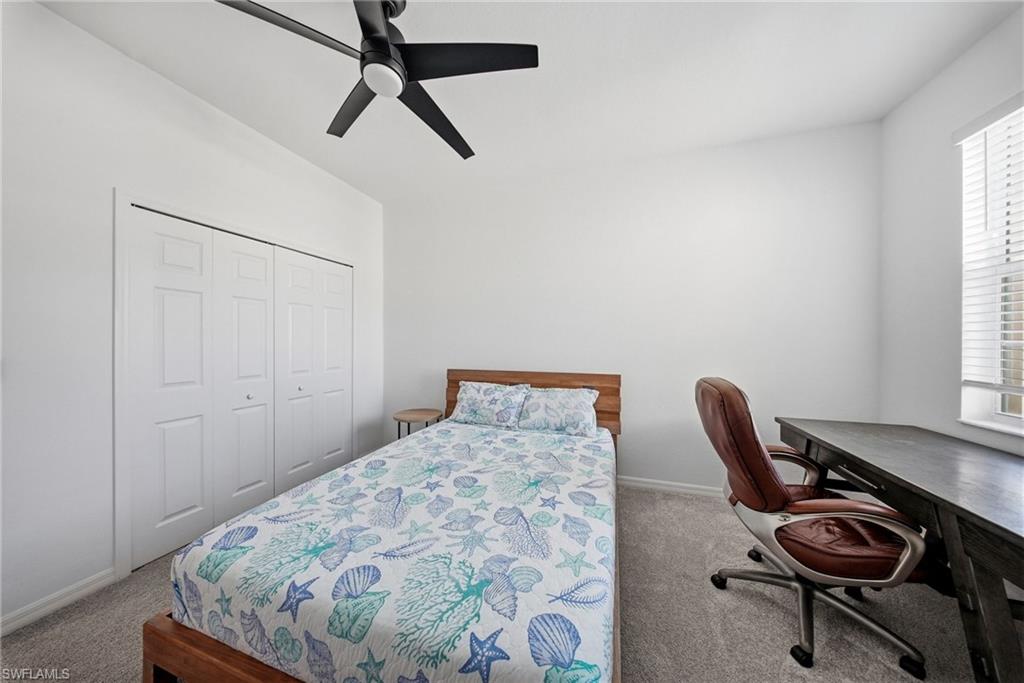 2930 Citrus Street Naples, FL 34120 - Photo 15 of 35 a bedroom with a bed a desk and chair