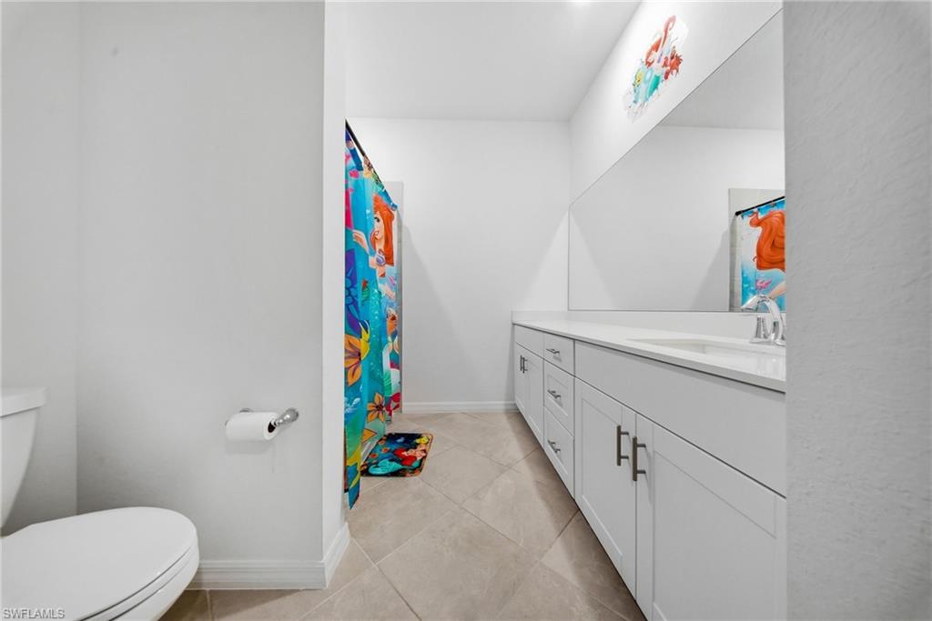 2930 Citrus Street Naples, FL 34120 - Photo 16 of 35 a bathroom with a sink toilet and vanity