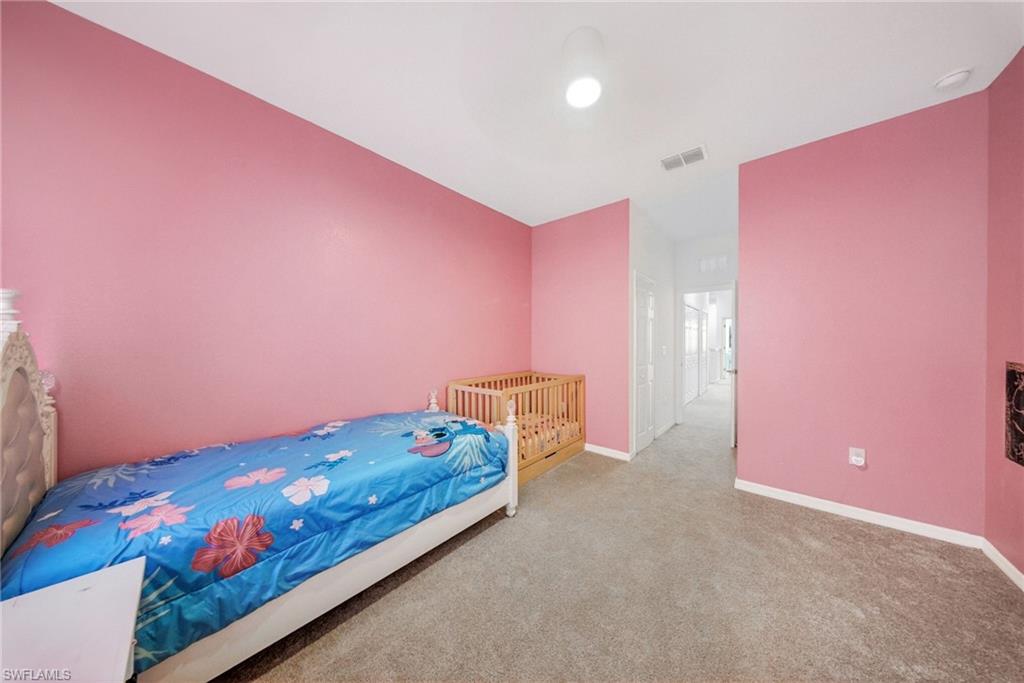 2930 Citrus Street Naples, FL 34120 - Photo 19 of 35 a bedroom with pink walls