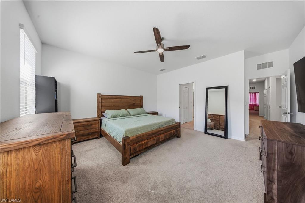 2930 Citrus Street Naples, FL 34120 - Photo 22 of 35 a bedroom with a bed and a dresser